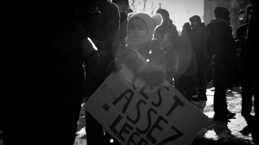a little girl holding a sign that says assist
